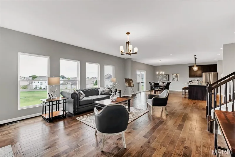Living room with stairway, dark wood-style floors, a chandelier, and recessed lighting — 1 TBB Sienna @ Kreder Farms, St Charles, MO 63304