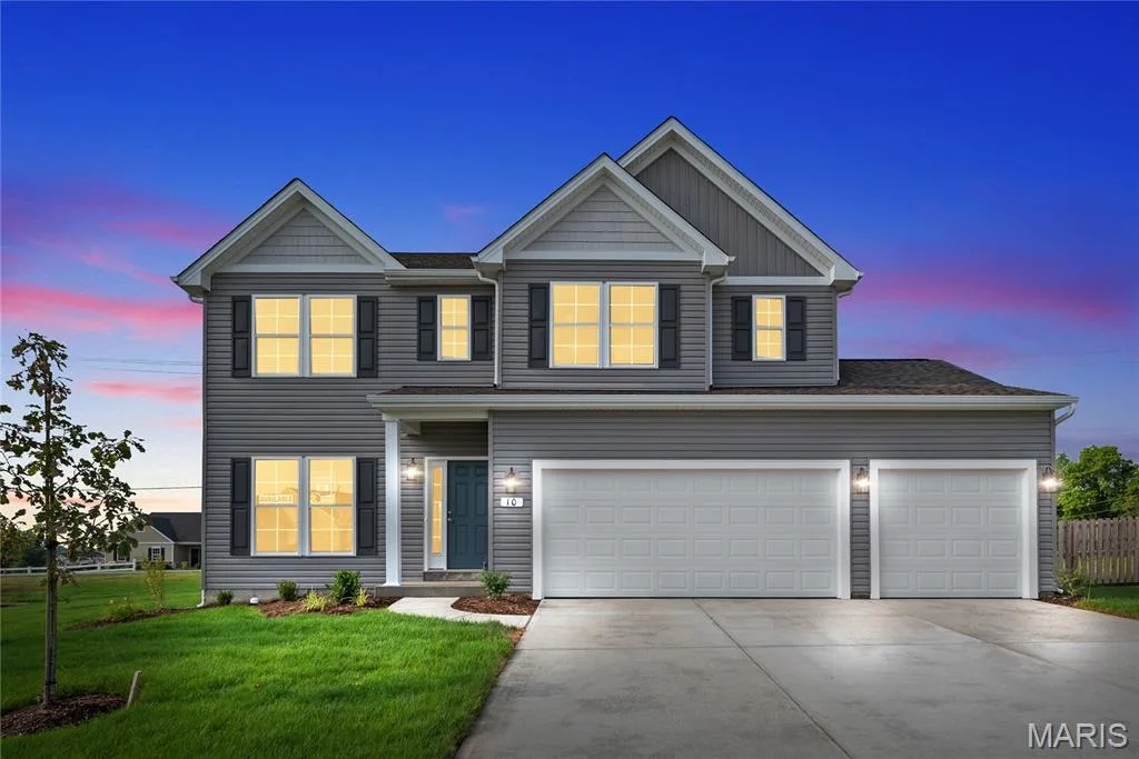 View of front of home featuring driveway, an attached garage, and board and batten siding — 1 TBB Barkley @ Kreder Farms, St Charles, MO 63304