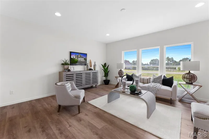 Living room featuring recessed lighting and wood finished floors — 1 TBB Barkley @ Kreder Farms, St Charles, MO 63304