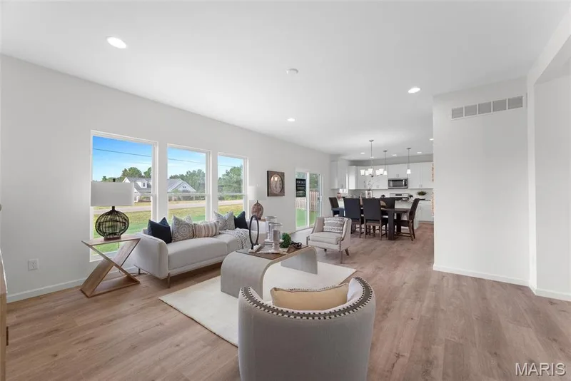 Living room with recessed lighting, light wood-style floors, and a chandelier — 1 TBB Barkley @ Kreder Farms, St Charles, MO 63304