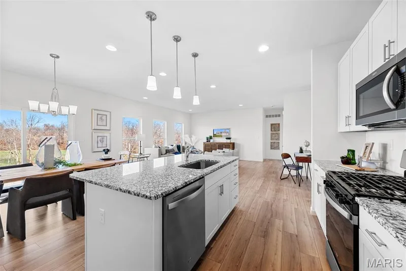 Kitchen featuring stainless steel appliances, white cabinets, light stone countertops, and recessed lighting — 1 TBB Westbrook @ Kreder Farms, St Charles, MO 63304