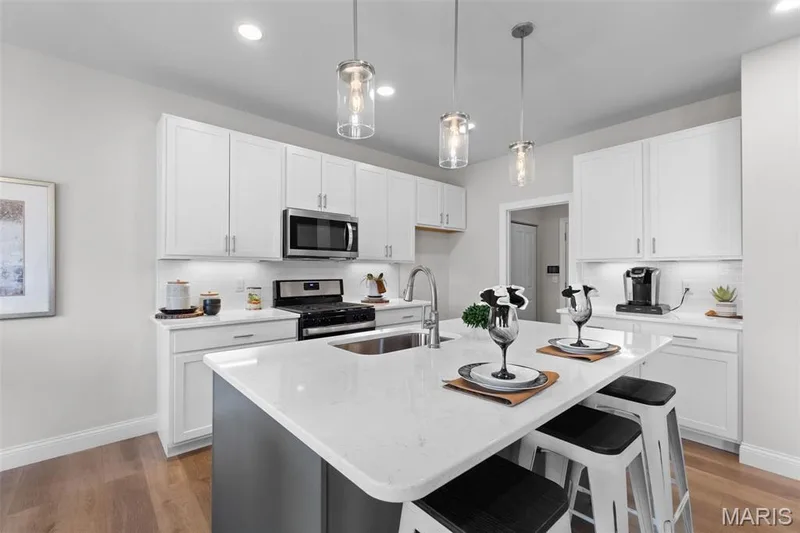 Kitchen featuring light wood-style flooring, white cabinets, a kitchen island with sink, and recessed lighting — 1 TBB Rockport @ Kreder Farms, St Charles, MO 63304