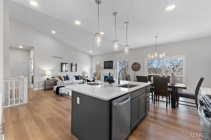 Kitchen with light wood finished floors, decorative light fixtures, open floor plan, light stone counters, and recessed lighting — 1 TBB Rockport @ Kreder Farms, St Charles, MO 63304