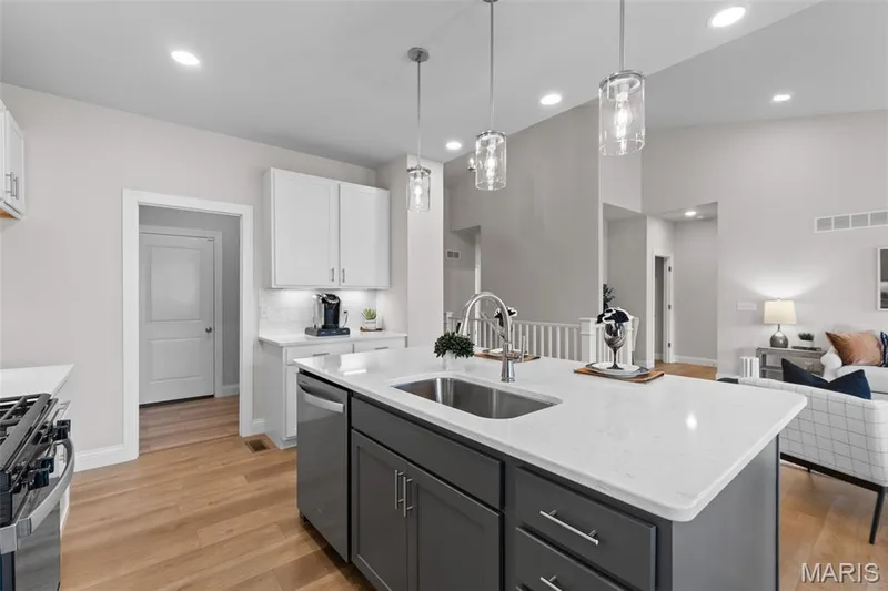 Kitchen featuring white cabinets, open floor plan, gray cabinetry, light wood-style flooring, and recessed lighting — 1 TBB Rockport @ Kreder Farms, St Charles, MO 63304