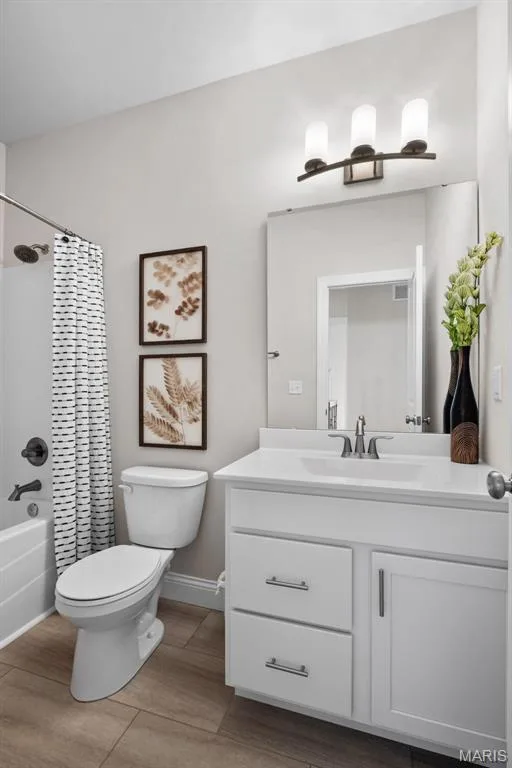Bathroom featuring shower / bathtub combination with curtain, vanity, and light wood finished floors — 1 TBB Rockport @ Kreder Farms, St Charles, MO 63304