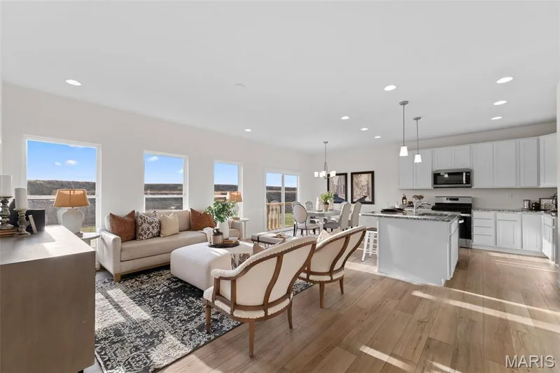 Living area featuring light wood finished floors, recessed lighting, and a chandelier — 1 TBB Savoy @ Kreder Farms, St Charles, MO 63304