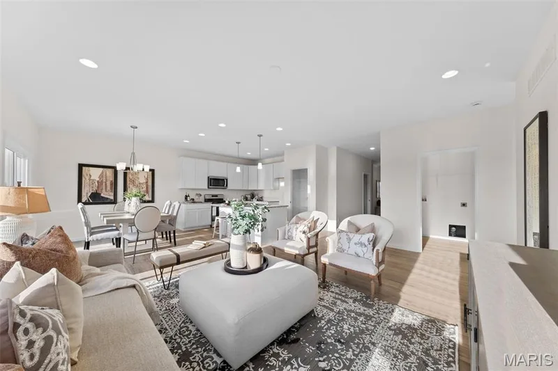 Living room featuring dark wood-style flooring, recessed lighting, and a chandelier — 1 TBB Savoy @ Kreder Farms, St Charles, MO 63304