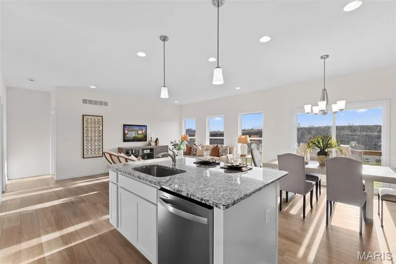 Kitchen with light stone counters, white cabinets, recessed lighting, dishwasher, and an island with sink — 1 TBB Savoy @ Kreder Farms, St Charles, MO 63304