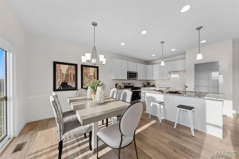 Dining room featuring recessed lighting, light wood-style flooring, and a chandelier — 1 TBB Savoy @ Kreder Farms, St Charles, MO 63304