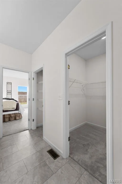Corridor with light colored carpet and light tile patterned flooring — 1 TBB Savoy @ Kreder Farms, St Charles, MO 63304