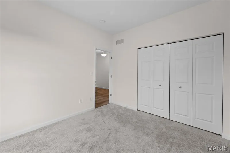 Unfurnished bedroom with carpet floors and a closet — 1 TBB Savoy @ Kreder Farms, St Charles, MO 63304