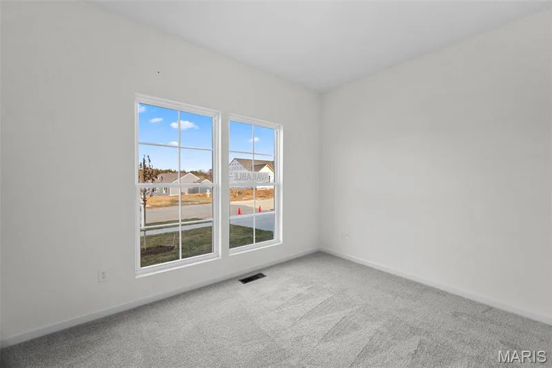 Spare room featuring light carpet and baseboards — 1 TBB Savoy @ Kreder Farms, St Charles, MO 63304