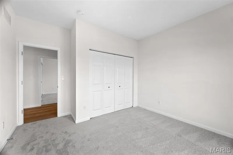 Unfurnished bedroom featuring carpet flooring and a closet — 1 TBB Savoy @ Kreder Farms, St Charles, MO 63304