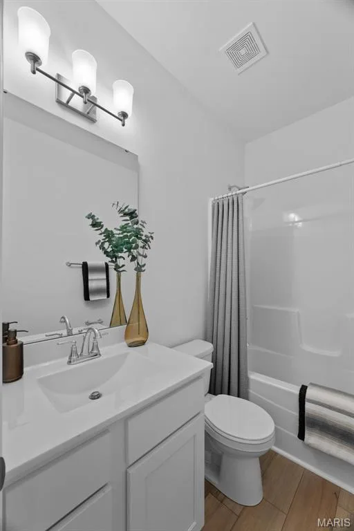 Bathroom with vanity, shower / tub combo, and light wood-type flooring — 1 TBB Savoy @ Kreder Farms, St Charles, MO 63304