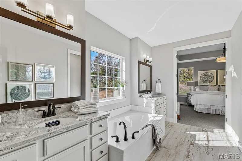 Full bath with ensuite bath, two vanities, and a garden tub — 1 TBB Kingston @ Kreder Farms, St Charles, MO 63304