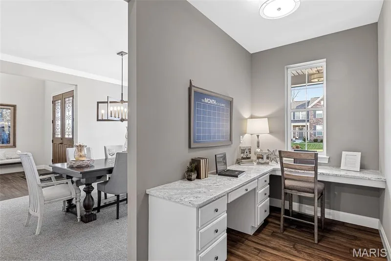 Office area featuring built in study area, dark wood-style floors, a chandelier, and crown molding — 1 TBB Kingston @ Kreder Farms, St Charles, MO 63304