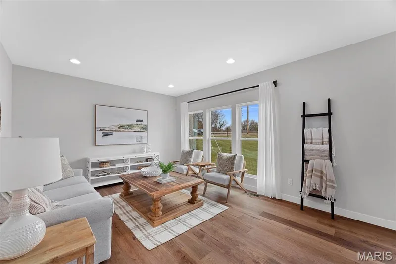 Living room with wood finished floors and recessed lighting — 1 TBB Bridgeport @ Kreder Farms, St Charles, MO 63304