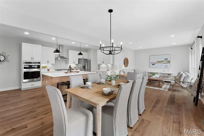 Dining area featuring a chandelier, dark wood-style floors, and recessed lighting — 1 TBB Bridgeport @ Kreder Farms, St Charles, MO 63304