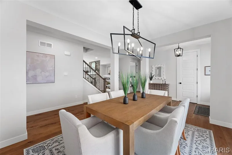 Dining area with stairway, dark wood-style flooring, and a chandelier — 1 TBB Bridgeport @ Kreder Farms, St Charles, MO 63304