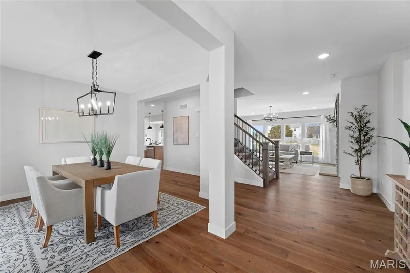 Dining area featuring a chandelier, stairs, wood finished floors, and recessed lighting — 1 TBB Bridgeport @ Kreder Farms, St Charles, MO 63304