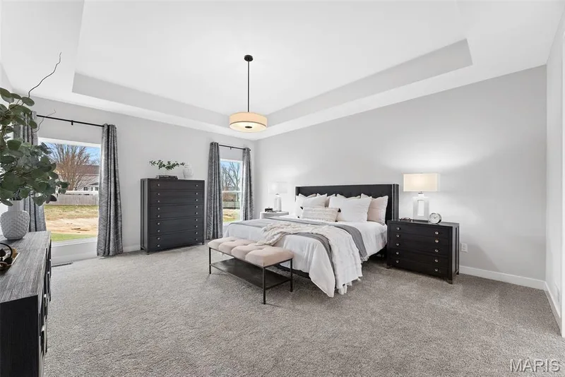 Carpeted bedroom with a tray ceiling — 1 TBB Bridgeport @ Kreder Farms, St Charles, MO 63304