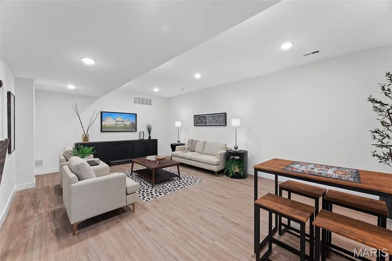 Living area with light wood finished floors and recessed lighting — 1 TBB Bridgeport @ Kreder Farms, St Charles, MO 63304