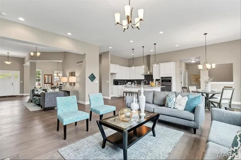 Living area with a chandelier, wood finished floors, and recessed lighting — 1 TBB Monaco @ Kreder Farms, St Charles, MO 63304