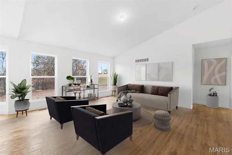 Living area featuring light wood finished floors and high vaulted ceiling — 1 TBB Sydney @ Kreder Farms, St Charles, MO 63304