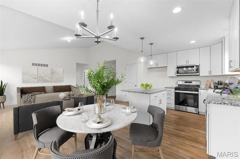 Dining space featuring lofted ceiling, light wood finished floors, a chandelier, and recessed lighting — 1 TBB Sydney @ Kreder Farms, St Charles, MO 63304