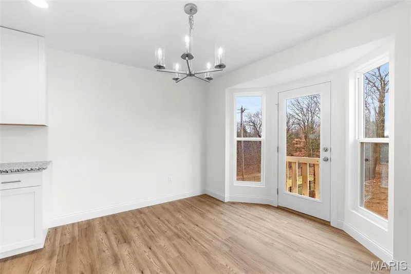 Unfurnished dining area with light wood-style flooring and a chandelier — 1 TBB Sydney @ Kreder Farms, St Charles, MO 63304