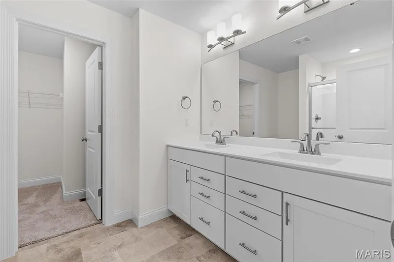 Bathroom with a walk in closet, a shower stall, and double vanity — 1 TBB Sydney @ Kreder Farms, St Charles, MO 63304