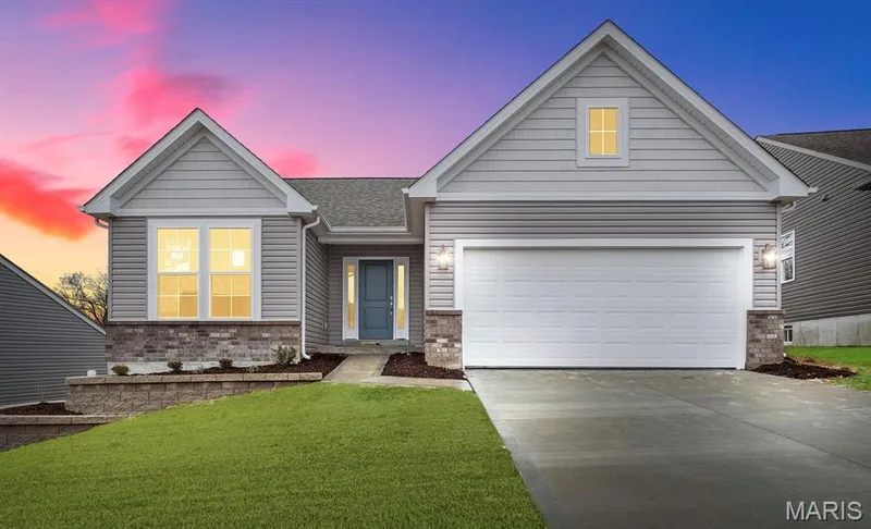 View of front of property featuring a front yard, driveway, a garage, brick siding, and a shingled roof — 1 TBB Sydney @ Kreder Farms, St Charles, MO 63304