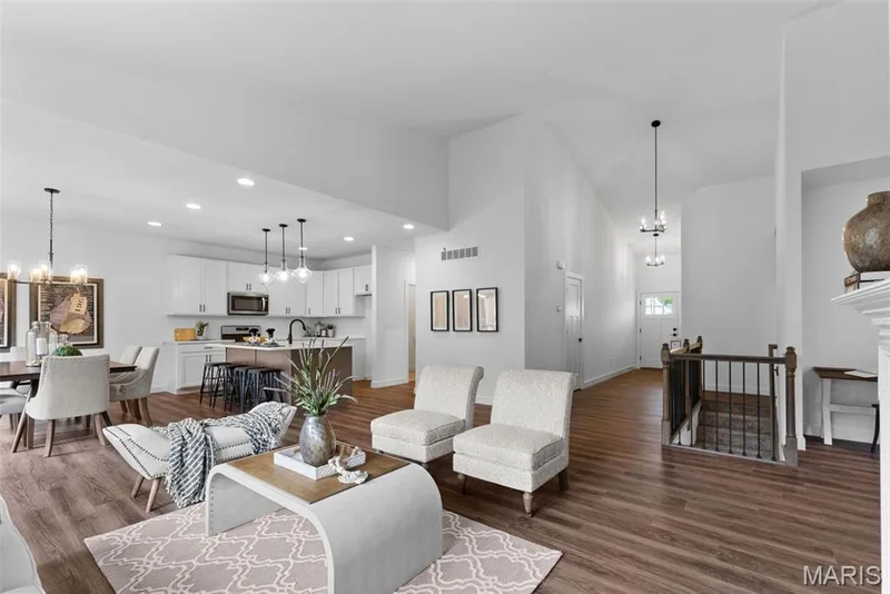 Living area featuring a chandelier, dark wood-style flooring, recessed lighting, and high vaulted ceiling — Rochester @ Providence Estates, Foristell, MO 63348