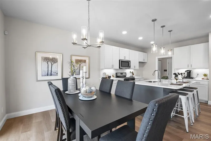 Dining space featuring light wood-style flooring, a chandelier, and recessed lighting — Rockport @ Providence Estates, Foristell, MO 63348