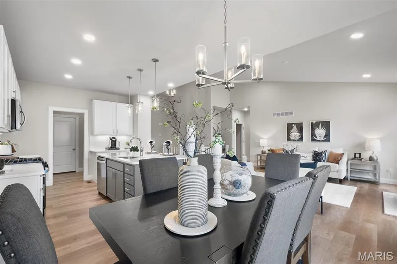 Dining room featuring recessed lighting, light wood-style floors, a chandelier, and vaulted ceiling — Rockport @ Providence Estates, Foristell, MO 63348