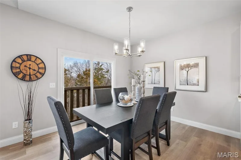 Dining area with light wood-style floors and a chandelier — 1 TBB Rockport @ Creekside Sommers, O'Fallon, MO 63367