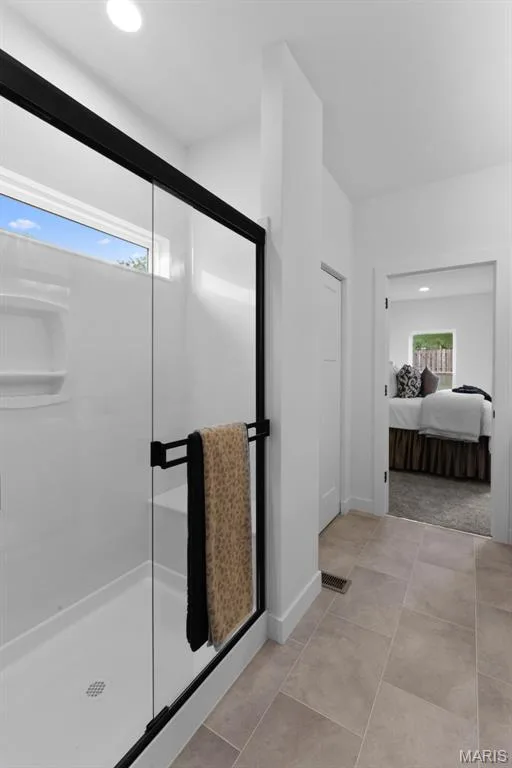 Ensuite bathroom featuring a stall shower, recessed lighting, and light tile patterned floors — 1 TBB Rochester @ Creekside Sommers, O'Fallon, MO 63367