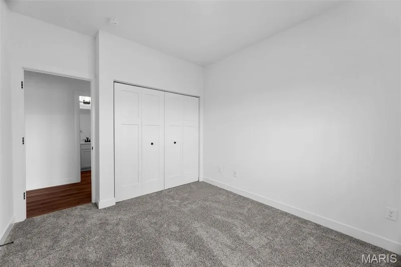 Unfurnished bedroom with carpet floors and a closet — 1 TBB Rochester @ Creekside Sommers, O'Fallon, MO 63367