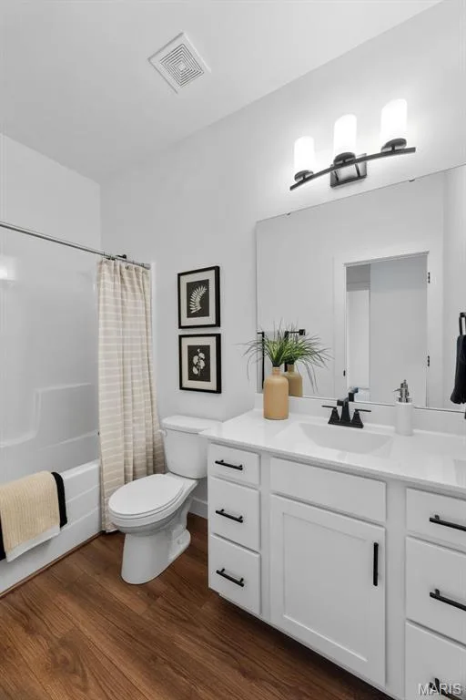 Bathroom with vanity, shower / tub combo with curtain, and dark wood-type flooring — 1 TBB Rochester @ Creekside Sommers, O'Fallon, MO 63367