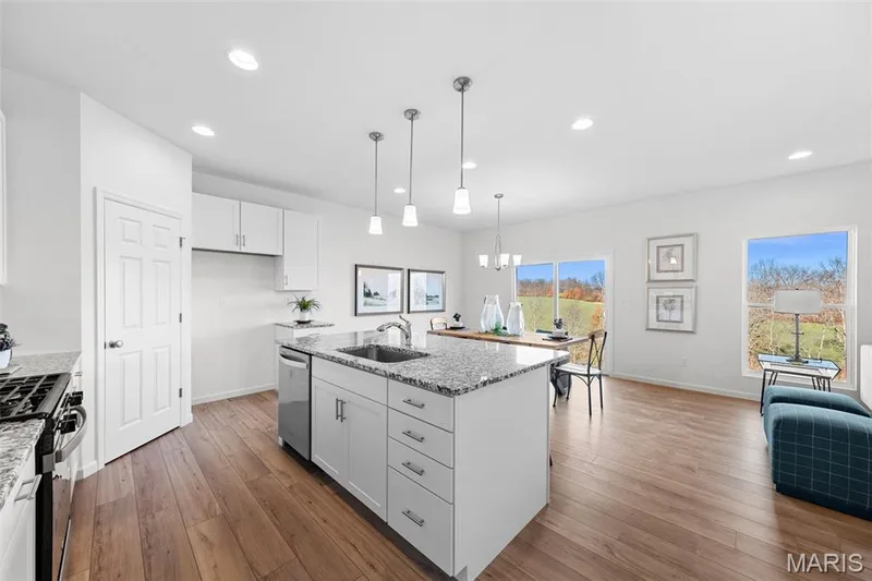 Kitchen with white cabinetry, light stone counters, recessed lighting, a chandelier, and pendant lighting — 1 TBB Westbrook @ Creekside Sommers, O'Fallon, MO 63367