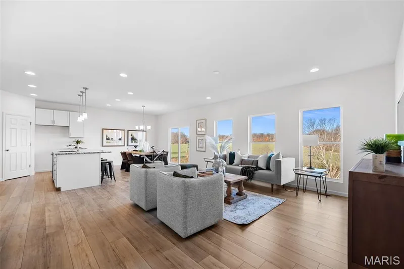 Living area with recessed lighting, light wood finished floors, and a chandelier — 1 TBB Westbrook @ Creekside Sommers, O'Fallon, MO 63367
