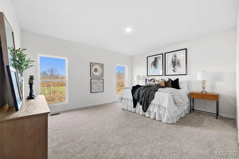 Bedroom featuring light carpet and baseboards — 1 TBB Westbrook @ Creekside Sommers, O'Fallon, MO 63367