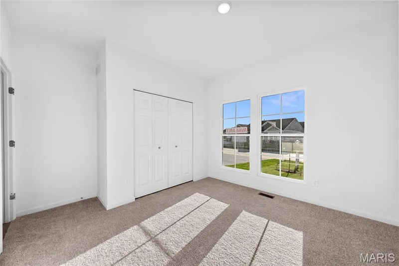 Unfurnished bedroom featuring light colored carpet and a closet — 1 TBB Westbrook @ Creekside Sommers, O'Fallon, MO 63367
