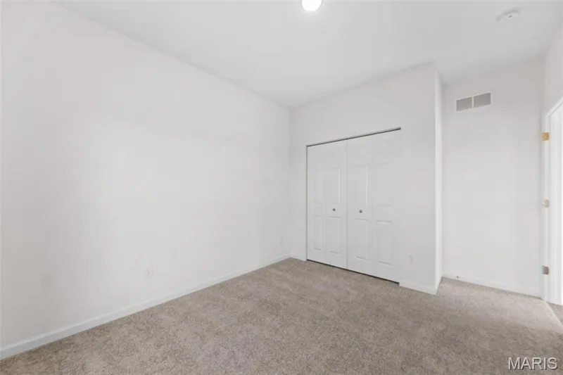 Unfurnished bedroom featuring carpet floors and a closet — 1 TBB Westbrook @ Creekside Sommers, O'Fallon, MO 63367