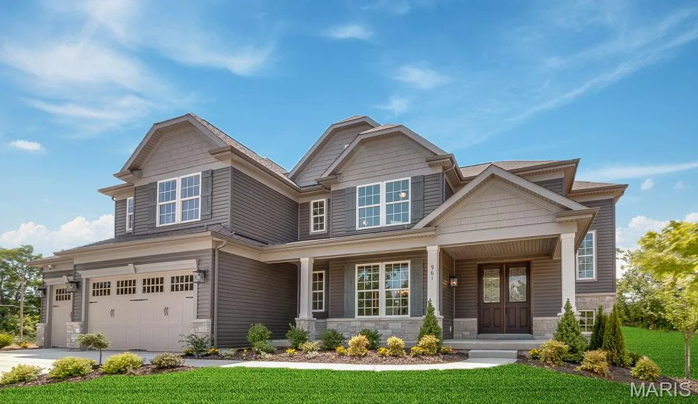 Craftsman-style home with covered porch, stone siding, an attached garage, a front lawn, and concrete driveway — 1 TBB Kingston @Willow Grove, Dardenne Prairie, MO 63368