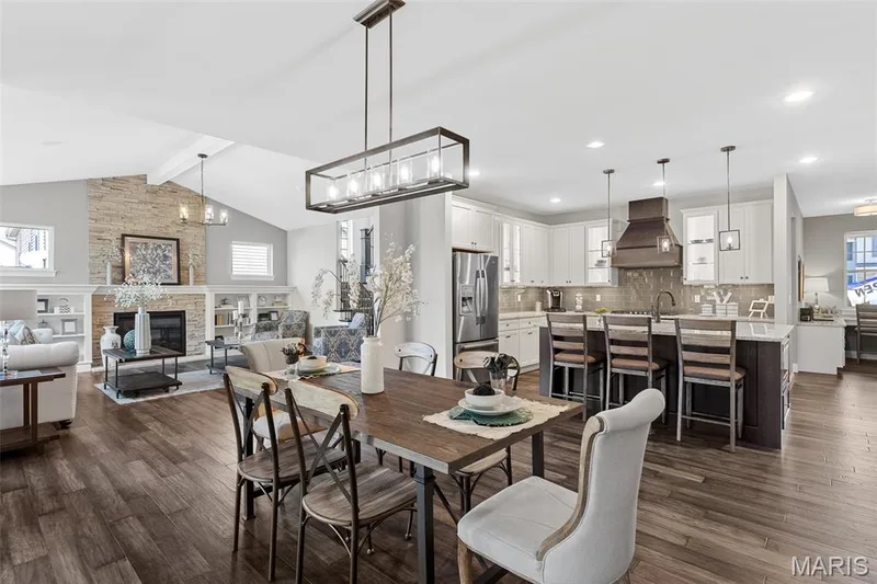 Dining space with a fireplace, dark wood-style flooring, and a chandelier — 1 TBB Kingston @Willow Grove, Dardenne Prairie, MO 63368