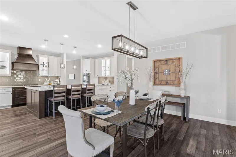 Dining area with dark wood-style flooring and recessed lighting — 1 TBB Kingston @Willow Grove, Dardenne Prairie, MO 63368