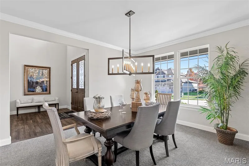 Dining space with crown molding, plenty of natural light, a chandelier, and carpet flooring — 1 TBB Kingston @ Chateau De Fond Du Lac, Lake St. Louis, MO 63367