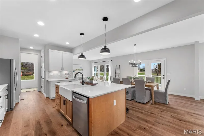 Kitchen featuring an island with sink, appliances with stainless steel finishes, plenty of natural light, light wood-style flooring, and recessed lighting — 1 TBB Bridgeport @ Chateau De Fond Du Lac, Lake St. Louis, MO 63367