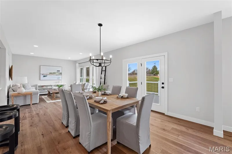 Dining area with a chandelier, light wood finished floors, and recessed lighting — 1 TBB Bridgeport @ Chateau De Fond Du Lac, Lake St. Louis, MO 63367